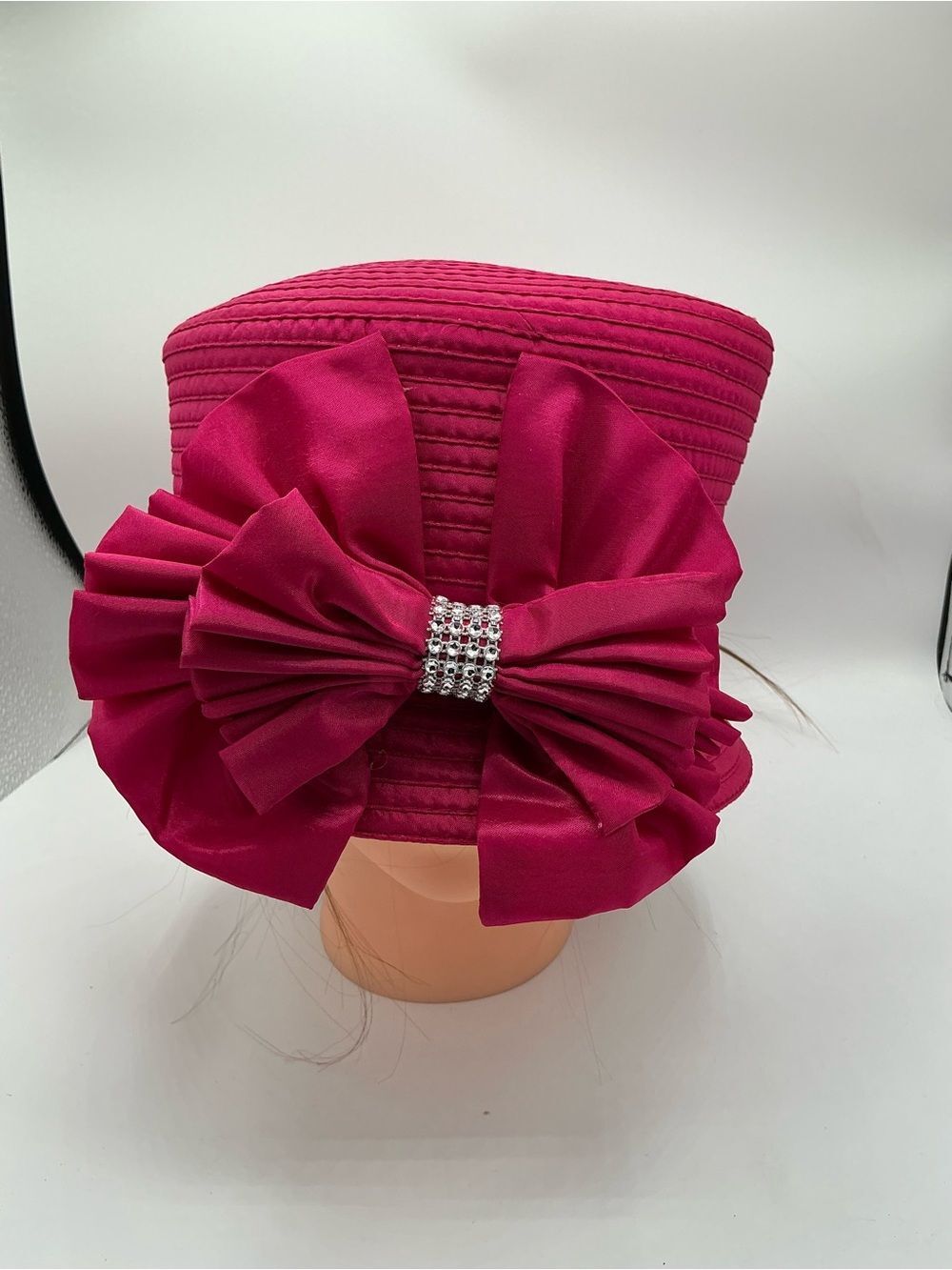 Fuchsia church, derby hat with a satin bow and sparkling rhinestone accents